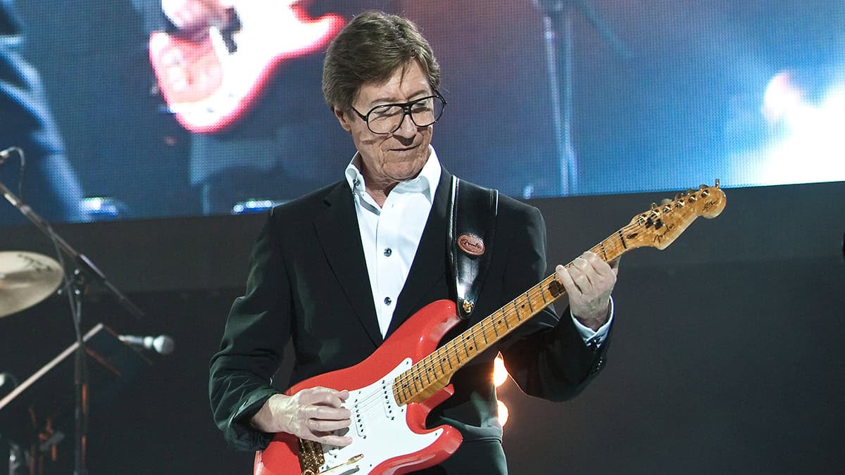 Hank Marvin playing guitar live.