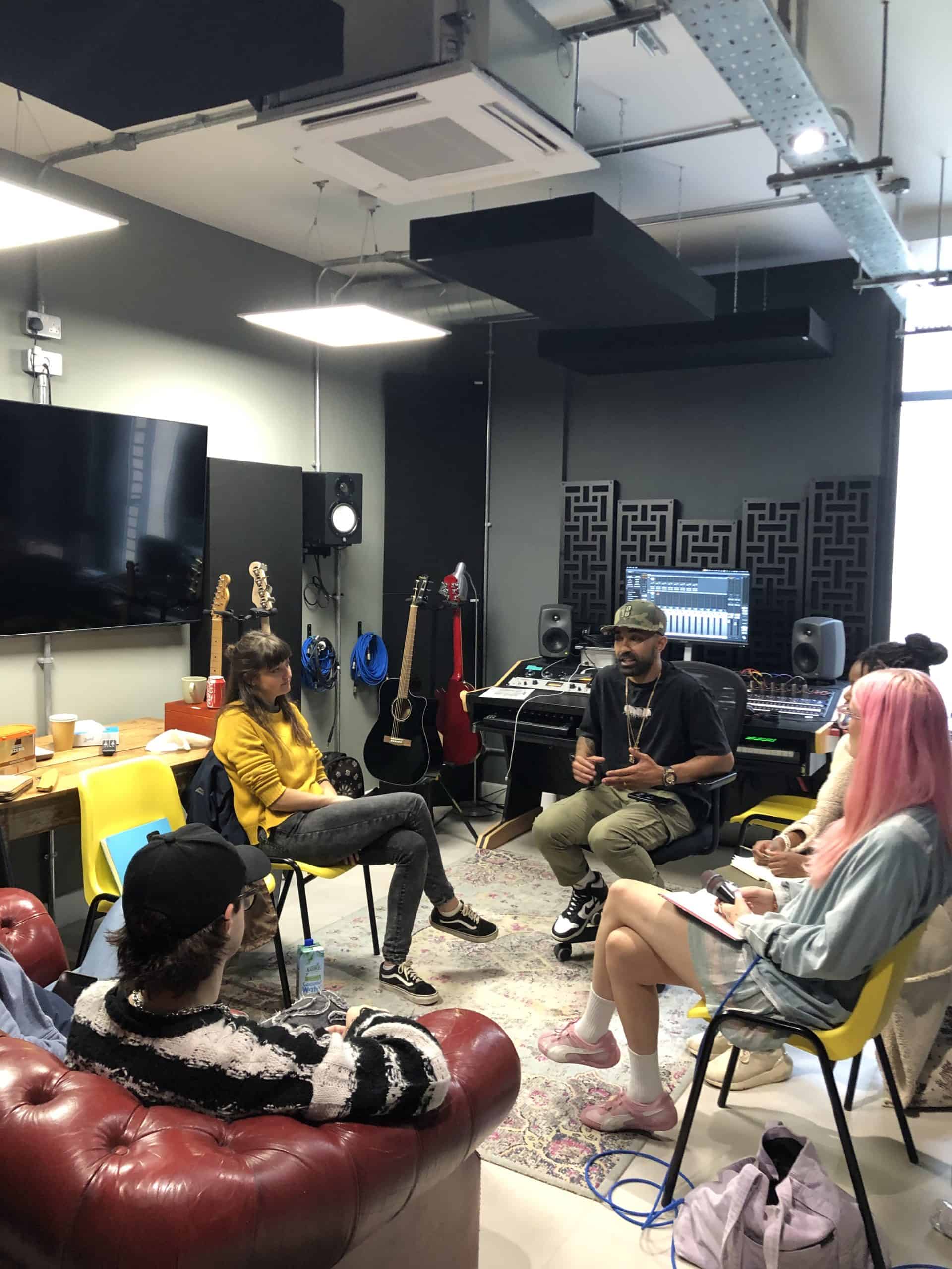 A group of people sitting in chairs in a room.