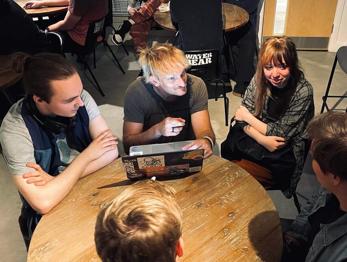 Independent artists meeting with a mentor to discuss career development and artist management opportunities.