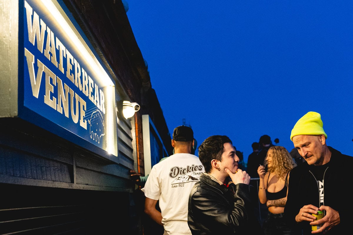 Artist and manager discussing career plans at a city music festival - showing artist management jobs and career opportunities in music.