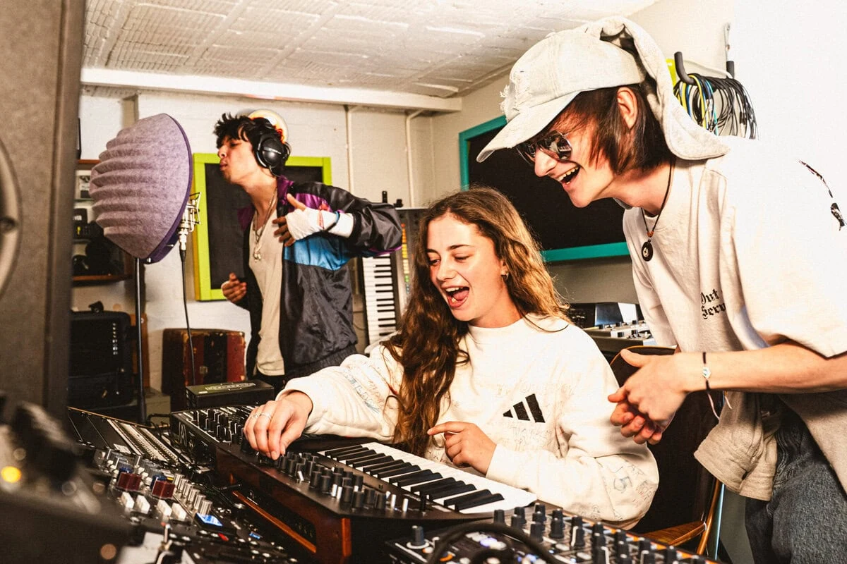 Musicians collaborating in a recording studio - exploring creative music jobs and careers in the music industry.