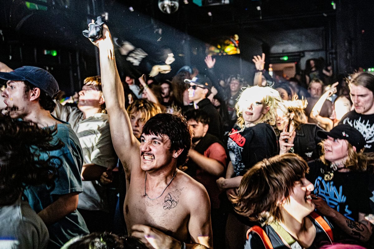 Energetic audience at a live concert - representing live music jobs, event management careers, and touring opportunities in the music industry.